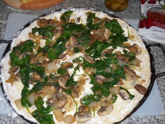 Onions, mushrooms, and spinach added on top of the cream cheese