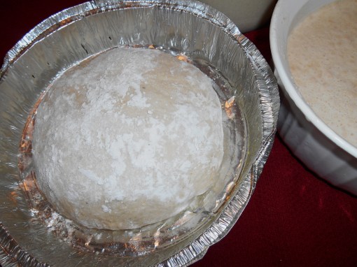 A newly formed loaf on the left, ready to rise for 60-90 minutes.  A bowl of newly fed starter on the right.